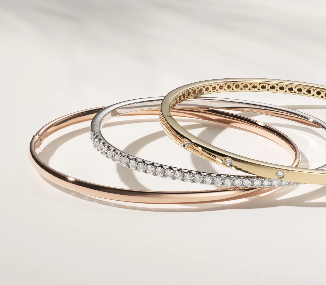 jewelry gifts under $2500: gold and diamond bracelets. 14k Rose Gold Bangle Bracelet (7.25 in)
This sleek and stylish 14-karat rose gold bangle bracelet will add high shine to any look. Perfect for daily wear, it features a convenient hinged opening and secure tongue clasp. 1 1/2 ct Pave Bangle Bracelet (7 in)
This dazzling pavé bangle bracelet will deliver hand-matched sparkle and fire to any look. Crafted in bright 14-karat white gold, it features a tongue clasp and safety lock for secure daily wear. Diamond Bangle Bracelet (7.5 in)
Dotted with natural diamond accents, this bangle bracelet will add a little shimmer to any look. Crafted in warm 14-karat yellow gold, it features a tongue clasp and safety lock for secure daily wear.