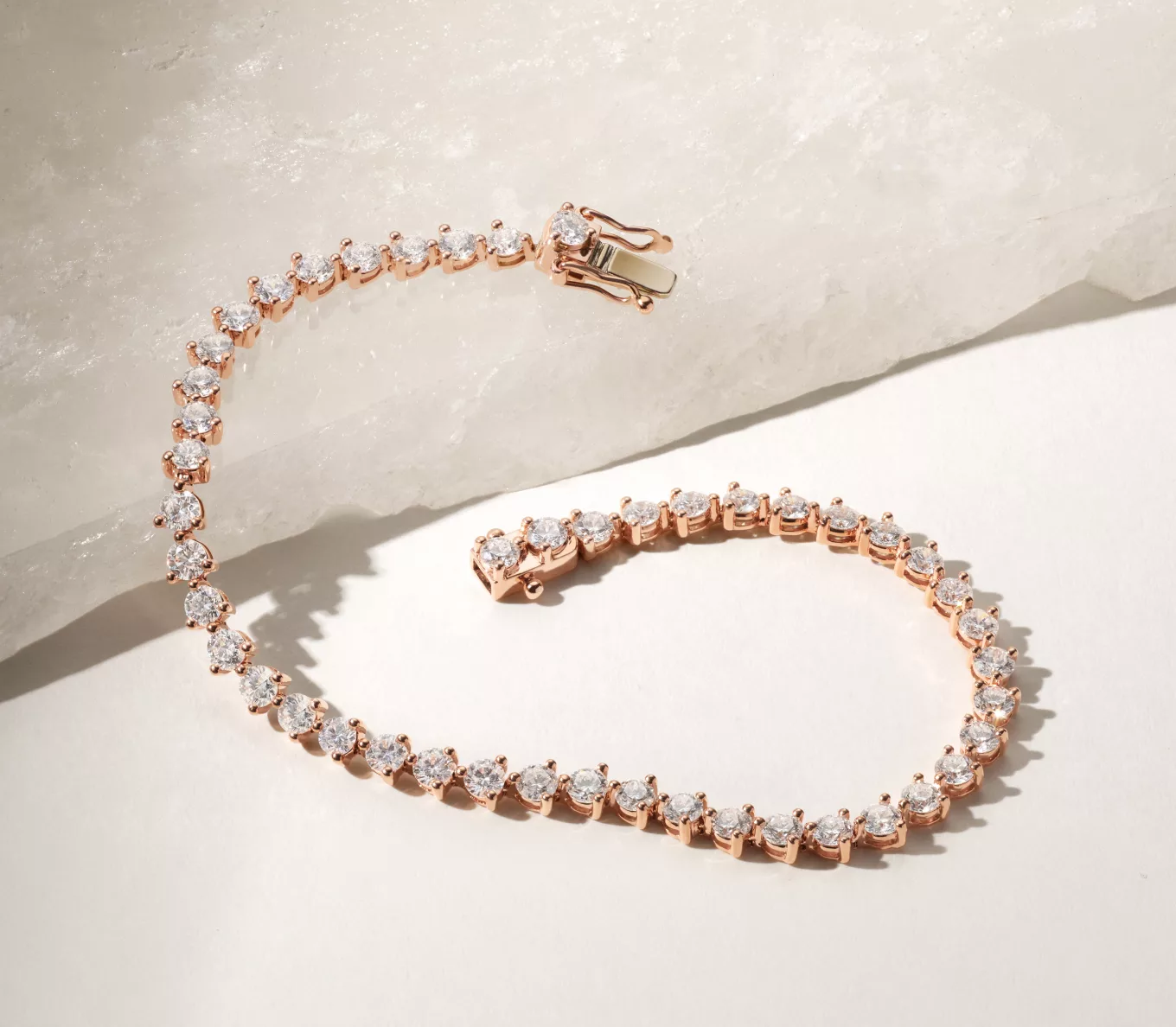 jewelry gifts over $5000: rose gold tennis bracelet. 5 ct. Diamond Tennis Bracelet (7 in) Put the spotlight on the sparkle and fire of hand-matched natural diamonds with this stunning three-prong tennis bracelet. Crafted in vivid 14-karat rose gold, it features a secure figure eight clasp.