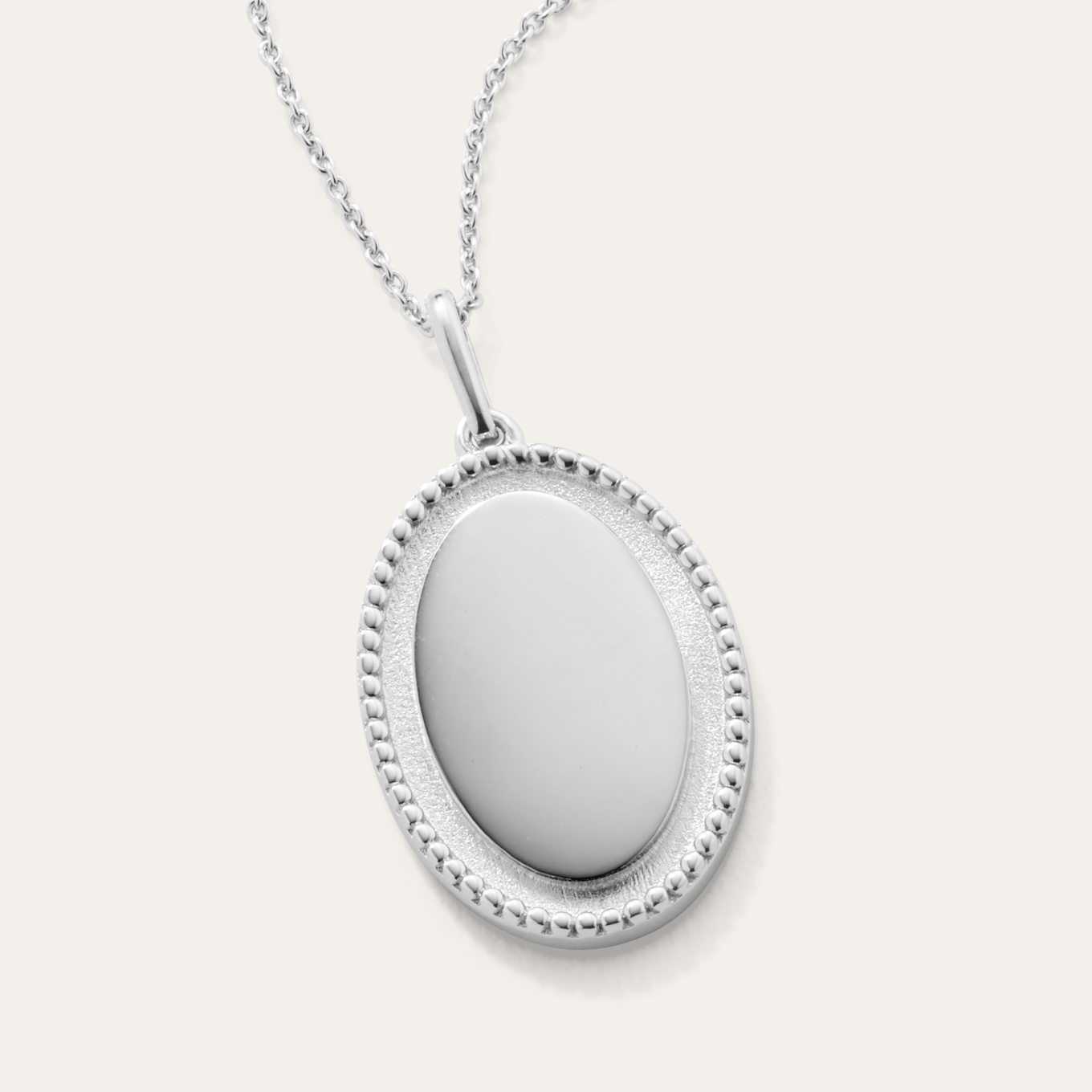 Odelia Engravable Sterling Silver Pendant This sterling silver pendant features a stylish oval shape and delicate milgrain detailing that offers vintage flair. Add a custom engraving to the middle, or let it shine all on its own. A matching rolo chain with a lobster clasp keeps this beautiful necklace secure.