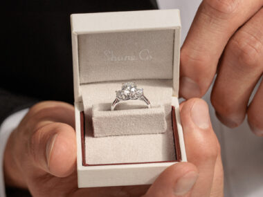 Three-stone engagement ring in a Shane Co. ring box