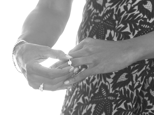 Woman Putting On Engagement Ring