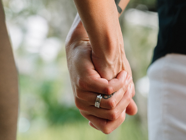 Close up of Casey's engagement ring as she holds hands with Karrie.