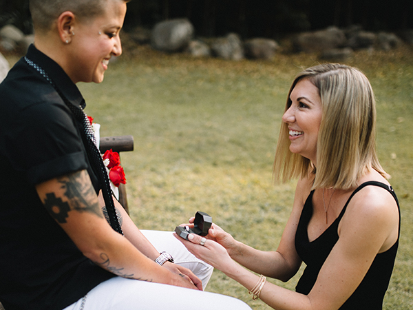 Karrie proposes to Casey on one knee with Shane Co. ring and ring box.