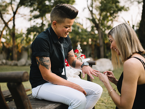 Karrie puts Casey's ring on for her.