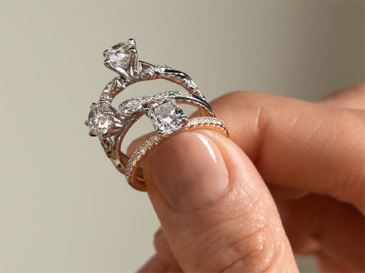 Hand Holding Three Diamond Engagement Rings