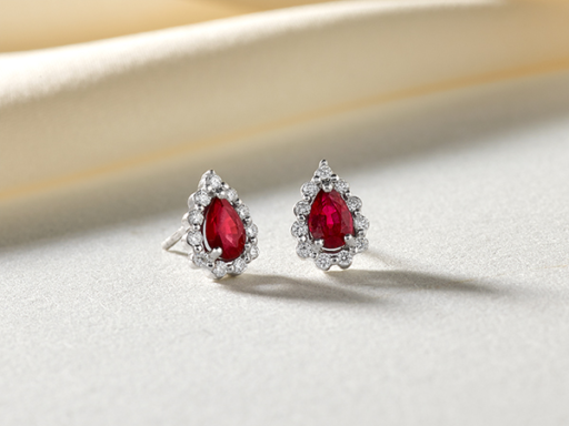 Teardrop shaped ruby and diamond studs in white gold.
