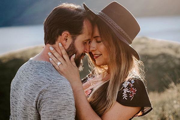 Couple with faces pressed against each other.