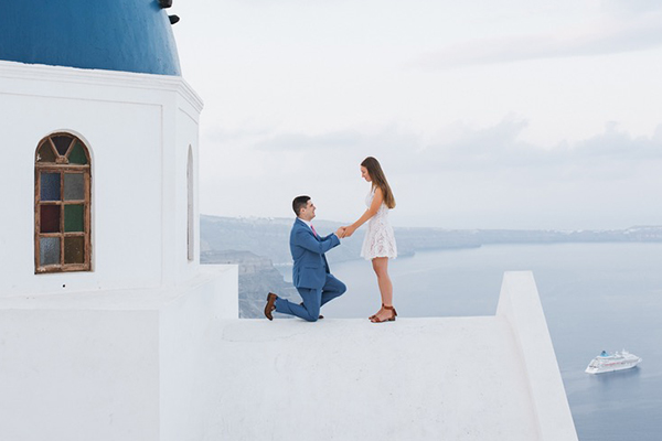 Couple proposing on top of a building in Greece.