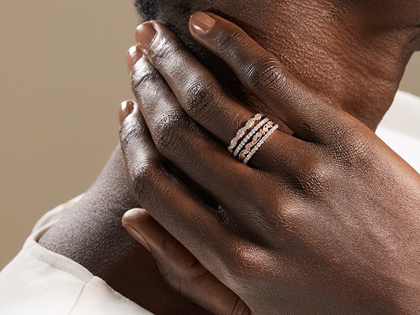 Woman wearing stacked wedding bands.