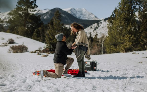 Man proposing to his girlfriend in the snow.