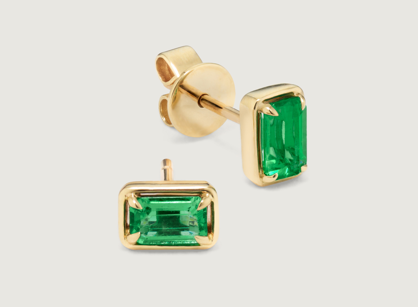 emerald stud earrings. Zelena Emerald Studs
Natural emeralds are the star of these beautiful earrings. A classic emerald cut showcases each emerald’s vibrant green color, while warm 14-karat yellow gold makes the perfect complement. A secure friction back offers worry-free wear. To care for natural emeralds, gently clean with mild soapy water and a soft cloth. Avoid harsh chemicals, ultrasonic jewelry cleaners, and extreme temperature changes.