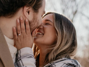 Couple smiling and kissing after a proposal