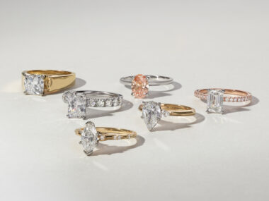 The image you sent me shows a dazzling display of seven engagement rings, each vying for attention. They seem like a curated collection, perhaps displayed by a jeweler or a bride-to-be who is considering her options. Here's a breakdown by metal type: Two white gold bands: At the bottom rest two classic white gold bands. Their thin and sleek design offers a touch of understated elegance. Textured yellow gold band: A wider yellow gold band sits above the white gold ones. Its textured design adds a unique detail and a touch of warmth. Widest ring in yellow gold: The widest ring in the stack takes center stage. It boasts a smooth, polished surface. Delicate rings: Three more delicate rings adorn the upper half of the stack. One features a thin white gold band with a small, sparkling stone. Another showcases a geometric design on a thin band, yellow gold for a touch of modern romance. Square stone stunner rose gold: Crowning the collection is a rose gold ring with a wide band set with a large, square gemstone. This ring makes a bold statement and could be a strong contender for the "yes" moment.