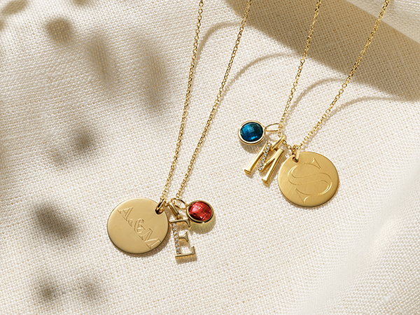 Charm necklaces with engravable pendants.