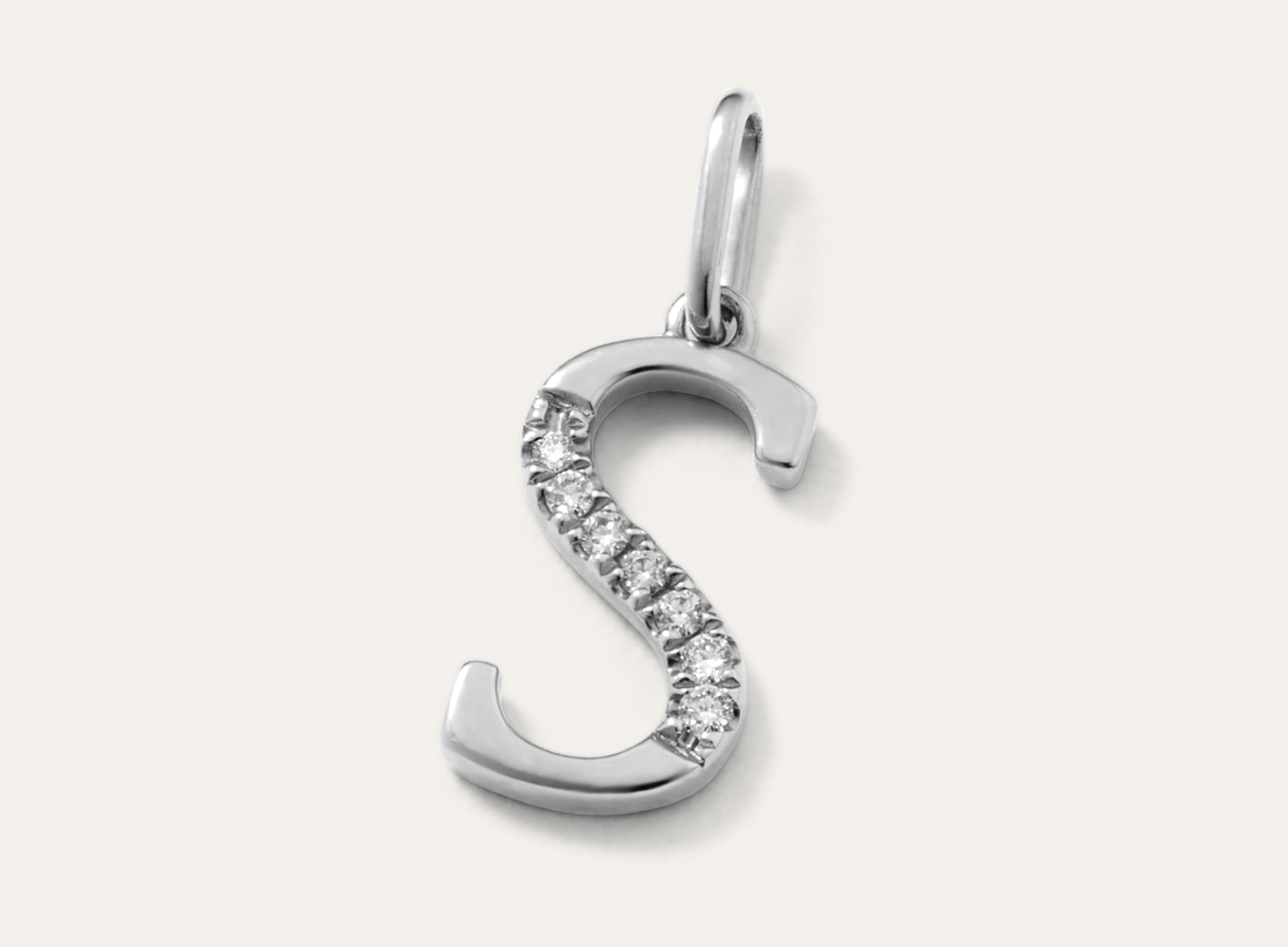 Diamond Accent Letter S Charm This letter S initial charm is crafted in bright 14-karat white gold and partially lined with natural diamond accents for a touch of sparkle. Add it to a chain to create a beautiful pendant, perfect for a gift or daily accessory.