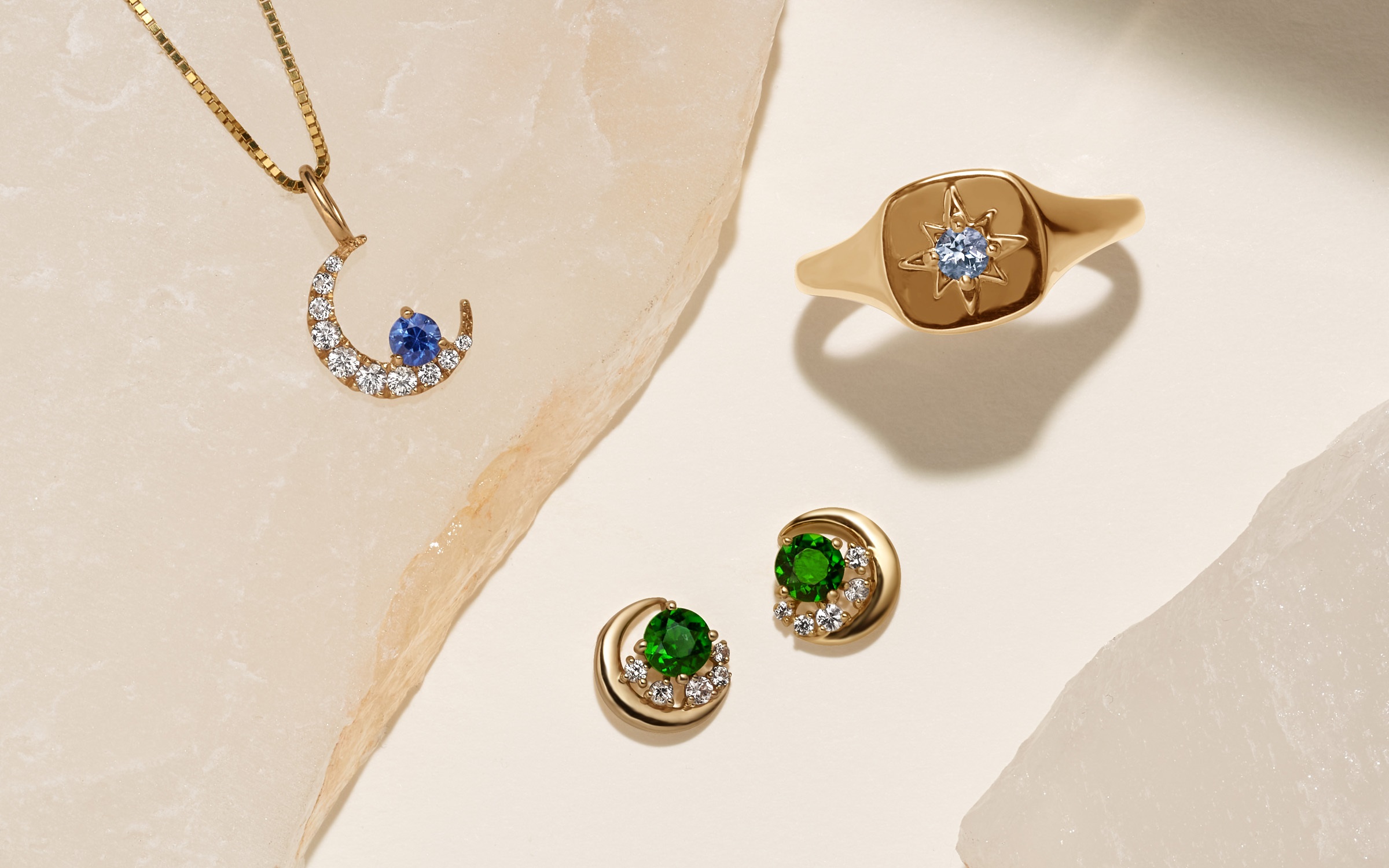 Half-moon necklace, signet ring, and gemstone earrings.