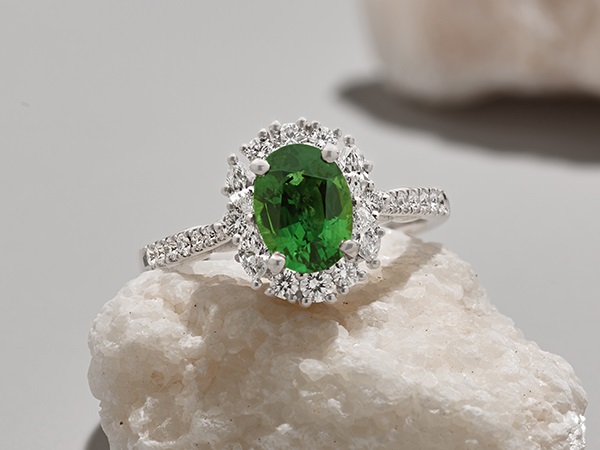 Green sapphire diamond halo engagement ring.