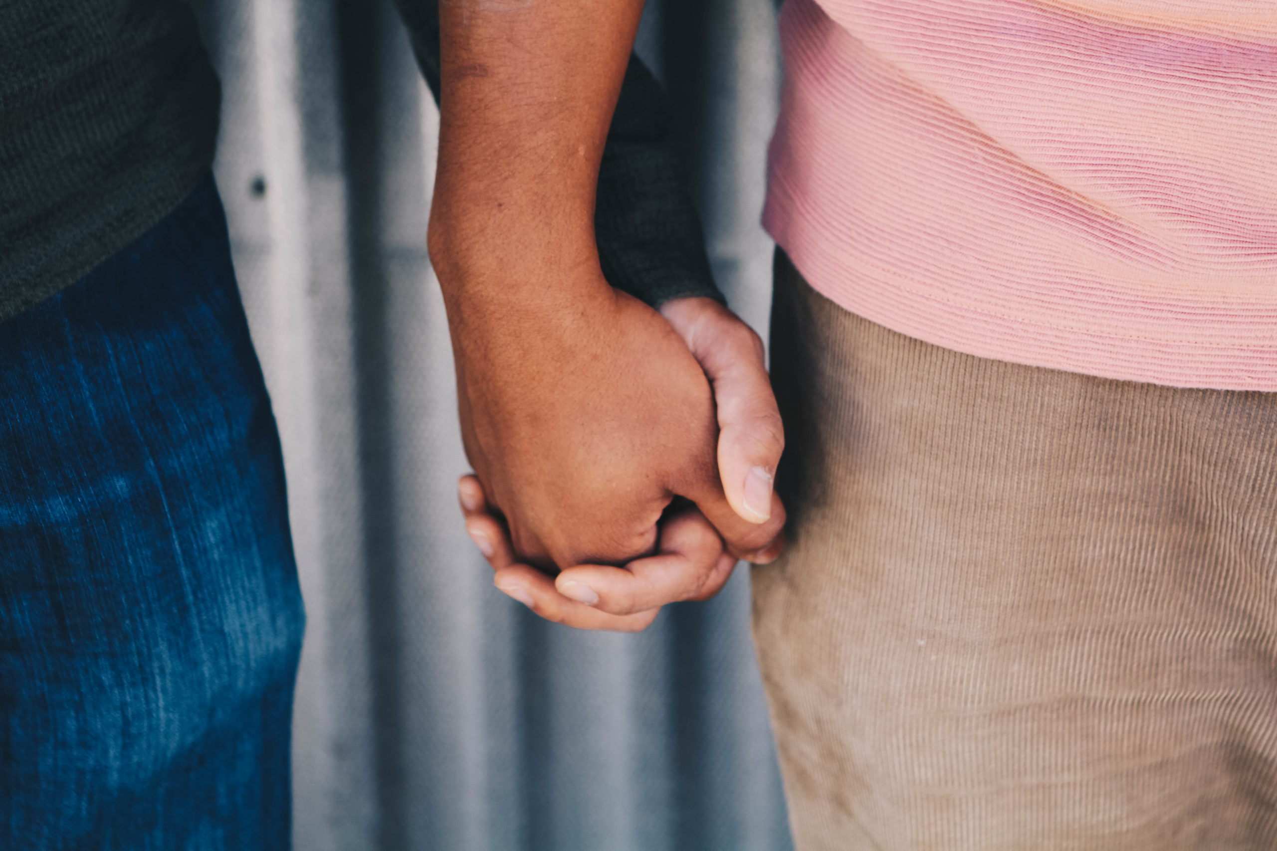 Two men holding hands.