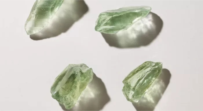 A collection of raw green gemstones