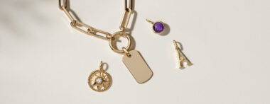 gold chain, A initial charm, star / compass charm