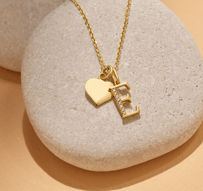 yellow gold "e" initial charm necklace with heart charm