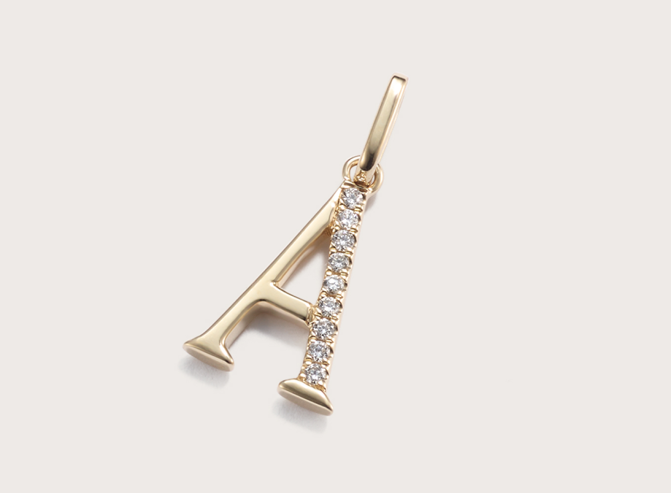Diamond Accent Letter A Charm This letter A initial charm is crafted in warm 14-karat yellow gold and partially lined with natural diamond accents for a touch of sparkle. Add it to a chain to create a beautiful pendant, perfect for a gift or daily accessory.