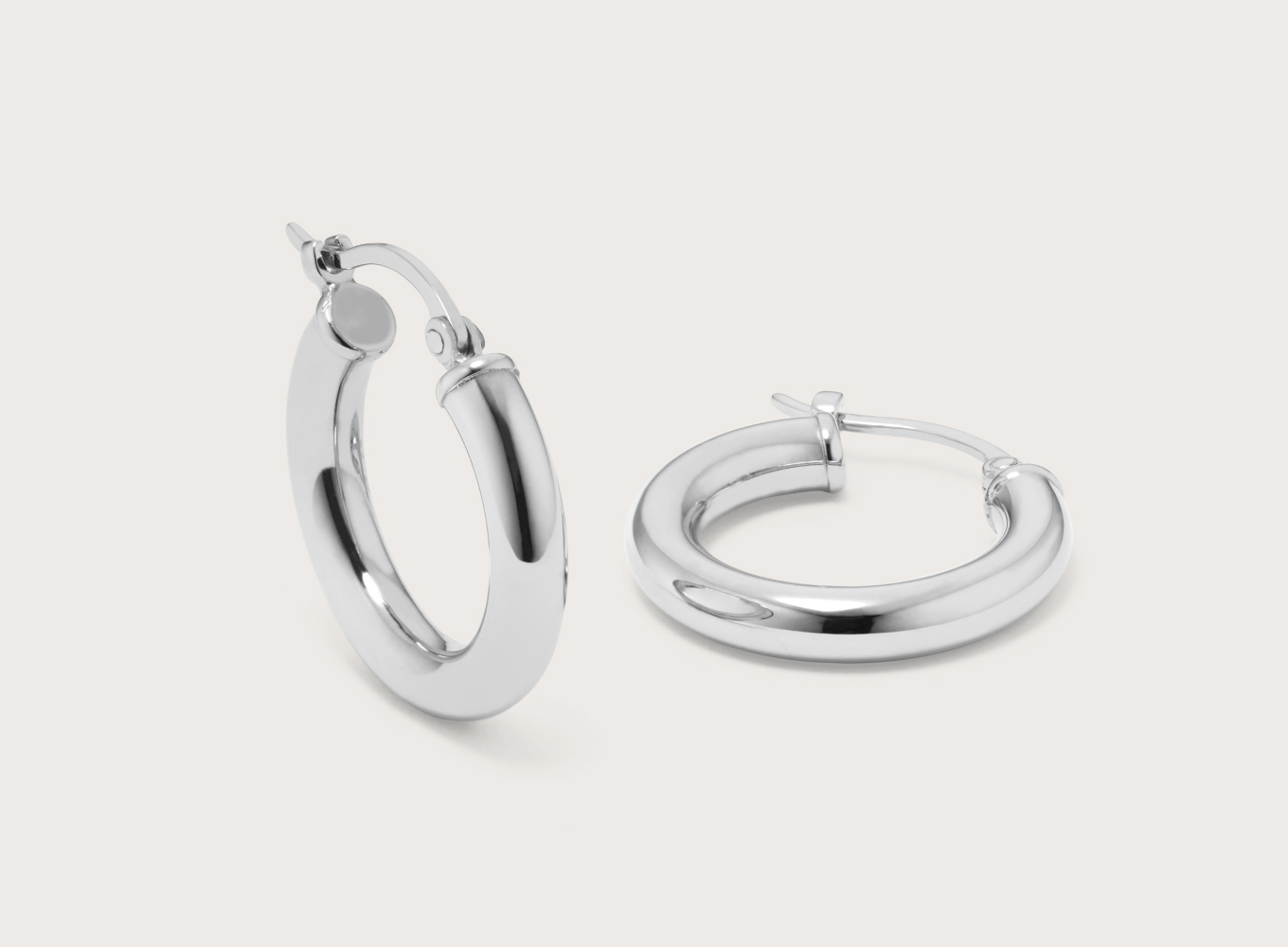 Classic Medium Sterling Silver Hoops These sterling silver hoops have a classic rounded profile and lightweight feel that’s perfect for every day. A lever back keeps these stylish earrings secure.