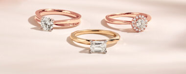 image of 3 diamond engagement rings. left is a rose gold ring with round diamond. Center, radiant cut diamond in a yellow gold ring. Right, a round diamond in a rose gold halo ring