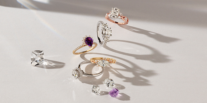 a variety of engagement rings, loose diamonds, and loose gemstones
