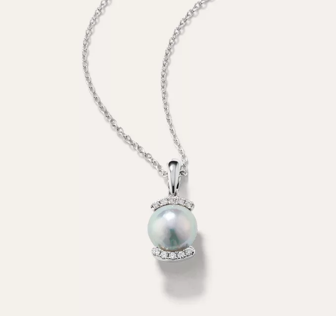 Silver Akoya Pearl Halo Pendant. A single baroque cultured Akoya pearl beams with a soft silver sheen among a partial halo of natural diamonds in this stunning 14-karat white gold pendant. 1 baroque cultured silver Akoya pearl at 7-8mm, 10 round natural diamond accents at approx. 0.05 tcw