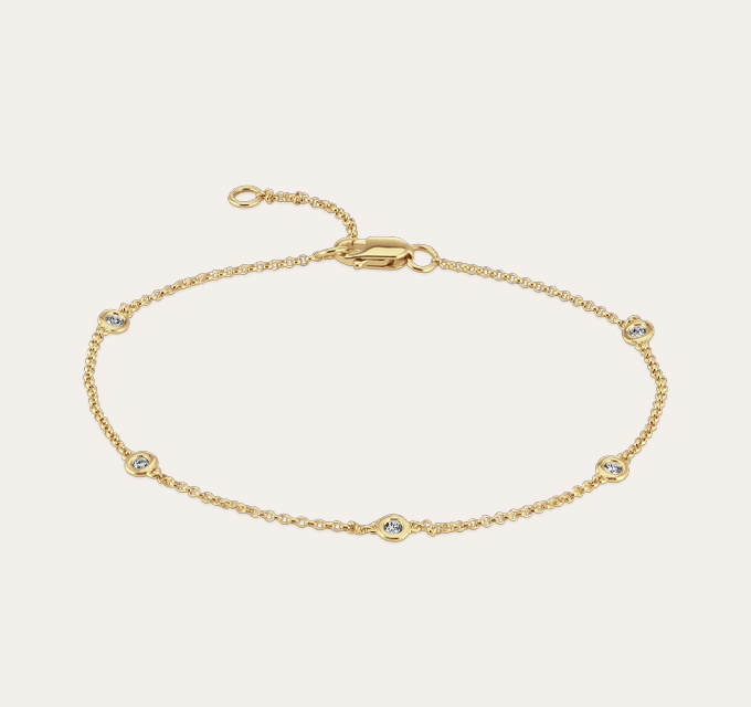 Ambrose Bezel-Set Diamond Bracelet in 14k Yellow Gold (8 in).   14 karat yellow gold, this modern station bracelet features five bezel-set round natural diamonds, at approximately .12 carat total weight.