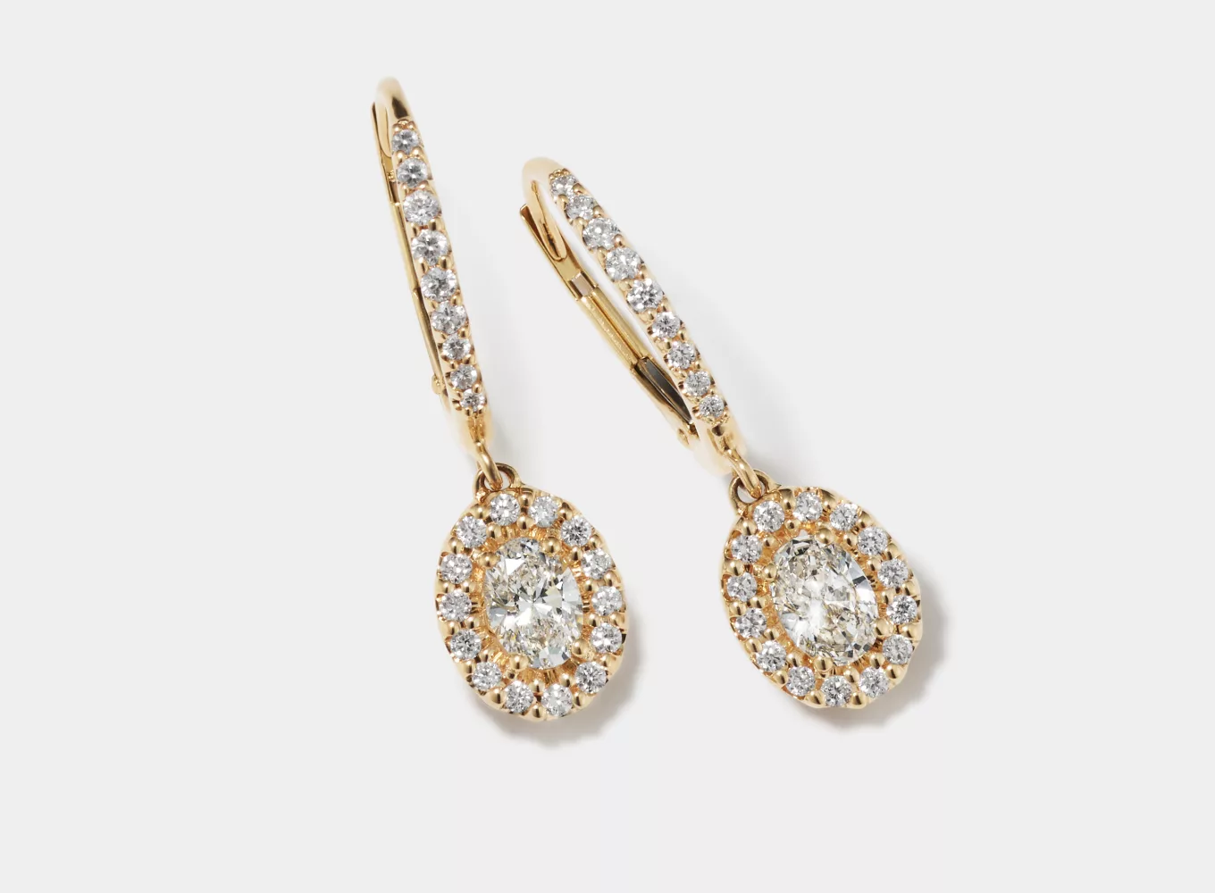 Oval 1 tcw Lab-Grown Diamond Halo Earrings. 48 round and oval lab-grown diamonds at 1 tcw, Dangle design, Approx. 1-inch length, Lever back, 14k yellow gold