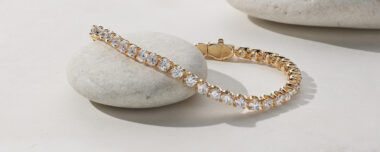10 tcw Lab-Grown Diamond Tennis Bracelet (7in). 41 round lab-grown diamonds at 10 tcw. 7-inch length. Box clasp. 14k yellow gold.