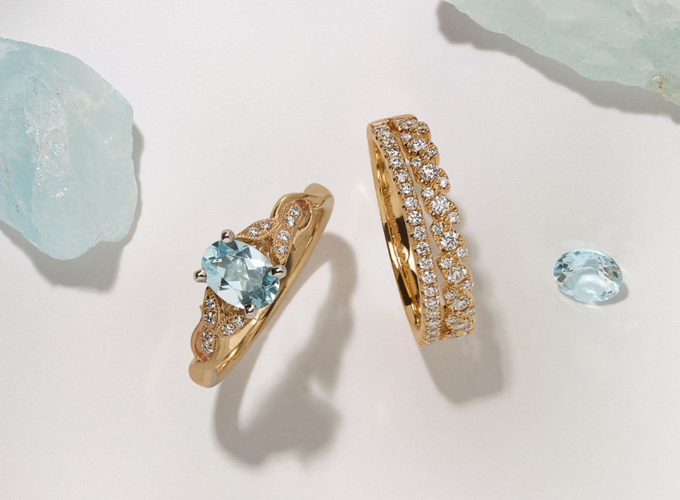 Matching wedding ring set featuring an aquamarine center stone in yellow gold. An engagement ring and wedding band set
