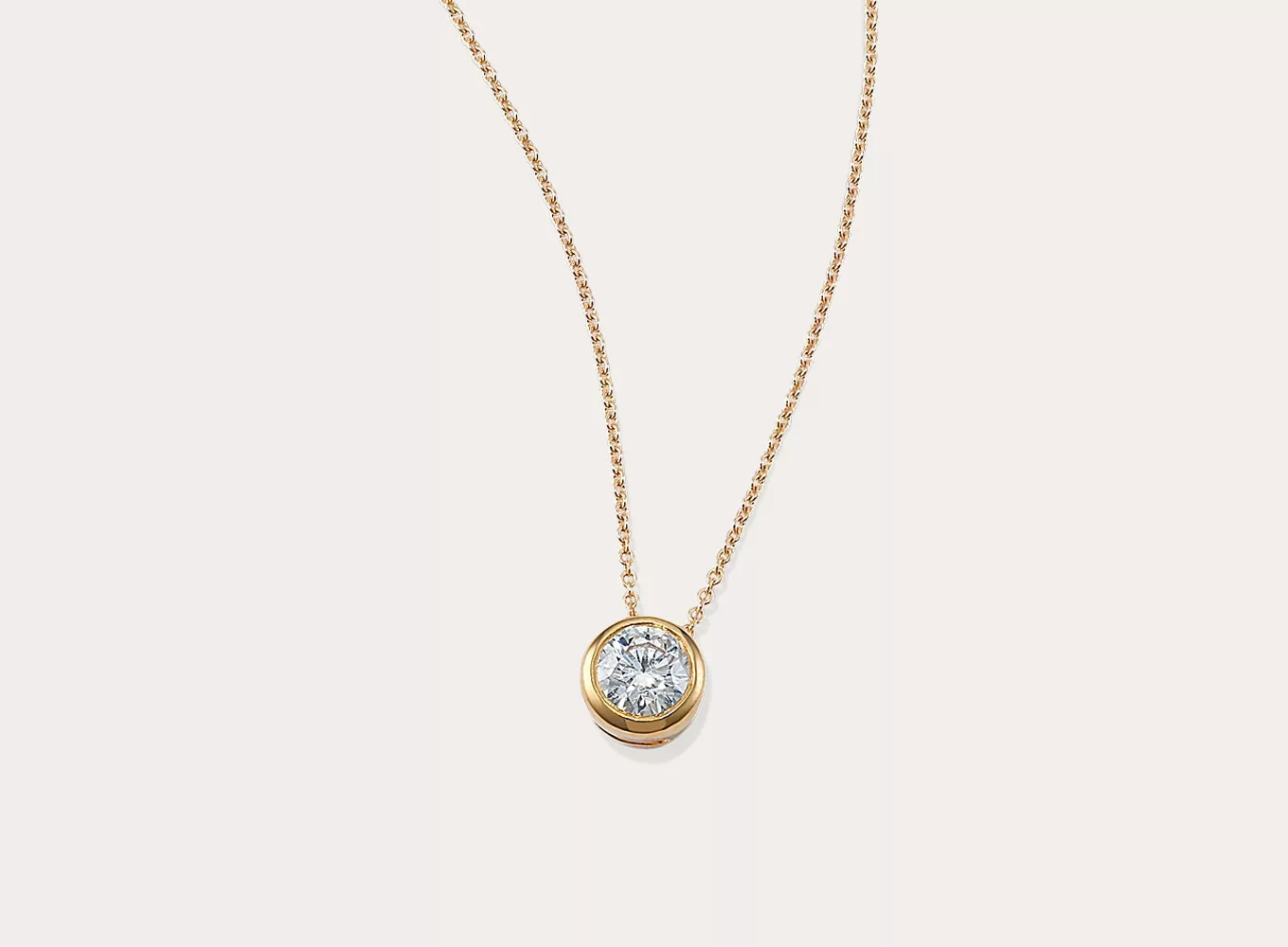 Round 1/3 ctw Lab-Grown Diamond Bezel Pendant This sparkling round lab-grown diamond pendant features a stylish bezel setting. Crafted in warm 14-karat yellow gold, a matching cable chain with a lobster clasp keeps this necklace secure.