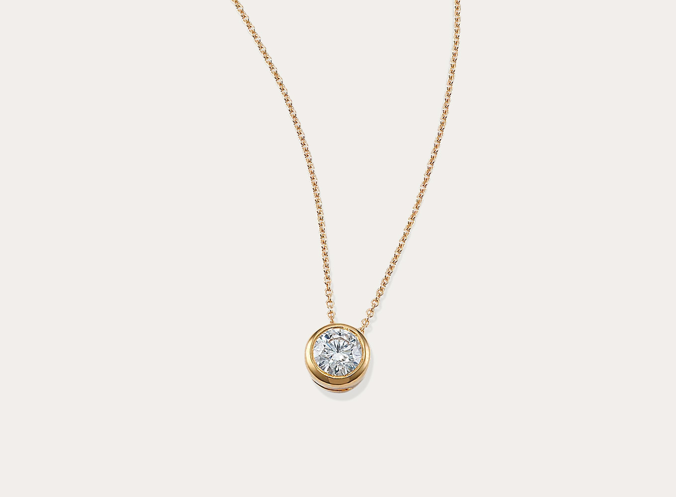 Round 1/3 ctw Lab-Grown Diamond Bezel Pendant This sparkling round lab-grown diamond pendant features a stylish bezel setting. Crafted in warm 14-karat yellow gold, a matching cable chain with a lobster clasp keeps this necklace secure.