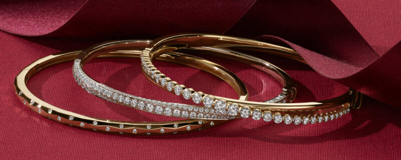 Quinn Geometric Diamond Bangle Bracelet. Natural diamonds dot this 14-karat yellow gold bangle bracelet with beautiful sparkle. This stylish bracelet also features a fun geometric shape and a hidden box clasp for a seamless look. Twist Diamond Bangle Bracelet. Natural diamonds twist around this 14-karat white gold bangle bracelet, delivering sparkle from every angle. It features a hinged design with a discrete box clasp and safety latch. Oasis Crossover Diamond Bangle Bracelet. This 14-karat yellow gold bangle bracelet features a stylish crossover design and natural diamonds that graduate in size towards the center. Complete with a discrete hidden clasp and secure safety latch, it makes a gorgeous daily accessory.