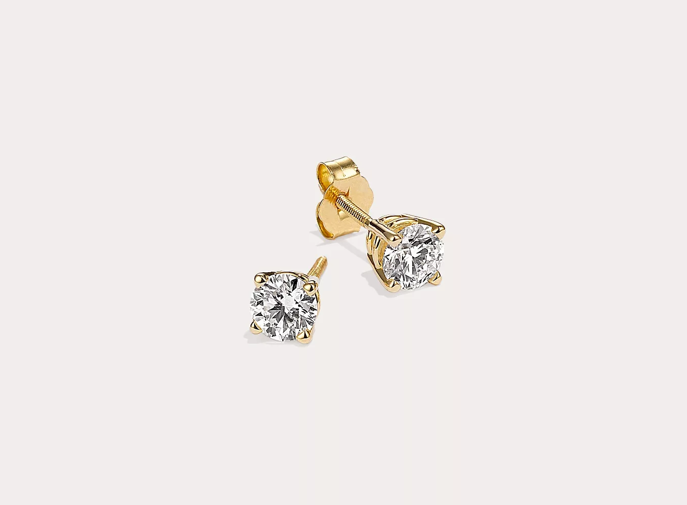 7/8 ct. Lab-Grown Diamond Stud Earrings in 14k Yellow Gold. These earrings are set in quality 14-karat yellow gold baskets, which has added nickel, zinc, silver, and copper alloys that make a bright shade. The lab-grown diamonds have been hand-matched for exceptional sparkle and fire. The push-on/screw-off backs securely hold the earrings in place.