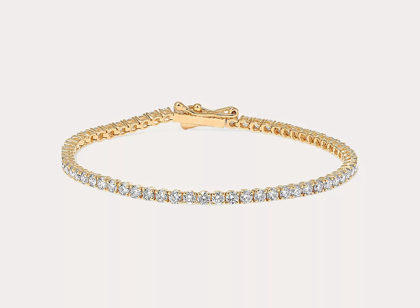 2 1/2 Diamond Tennis Bracelet (8 in) Leave them speechless with this natural diamond tennis bracelet. Set in bright 14-karat yellow gold, the hand-matched diamonds will sparkle from across the room. A secure box clasp and figure-eight safety latch offer worry-free wear.
