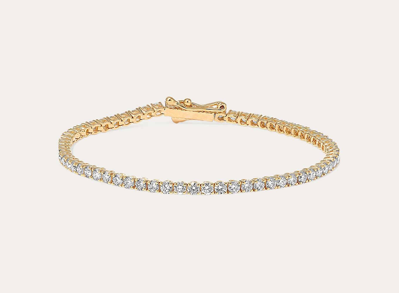 2 1/2 Diamond Tennis Bracelet (8 in) Leave them speechless with this natural diamond tennis bracelet. Set in bright 14-karat yellow gold, the hand-matched diamonds will sparkle from across the room. A secure box clasp and figure-eight safety latch offer worry-free wear.