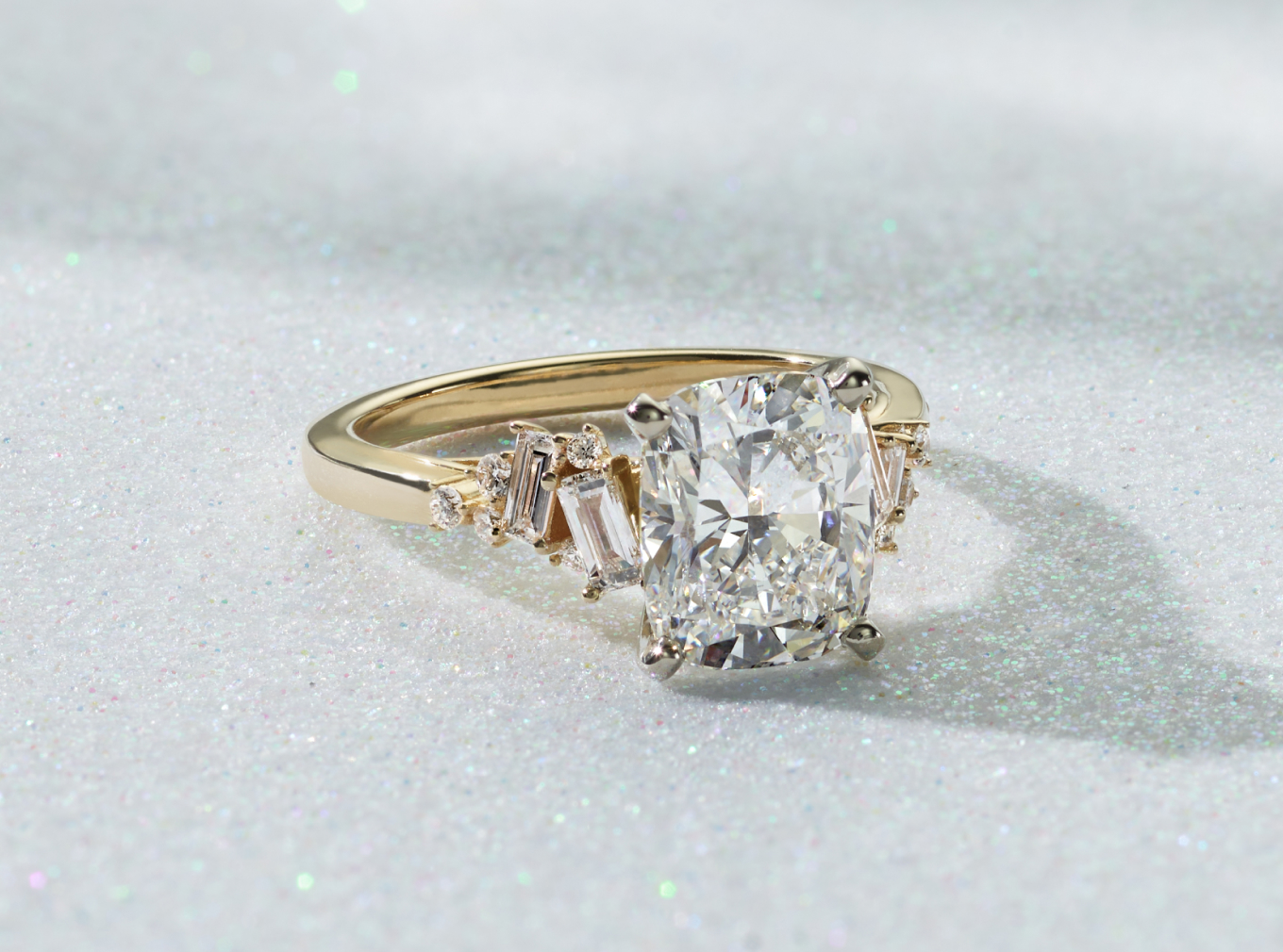 Lillian Engagement Ring Baguette and round natural diamond accents seem to dance along the band of this beautiful engagement ring setting. Crafted in warm 14-karat yellow gold, it features intricate scrollwork along the profile view for a vintage-inspired touch. Add the center stone of your dreams to complete this stunning ring. For more information on selecting your center stone, live chat online, call a customer service representative at 1-866-467-4263, or visit one of our store locations.