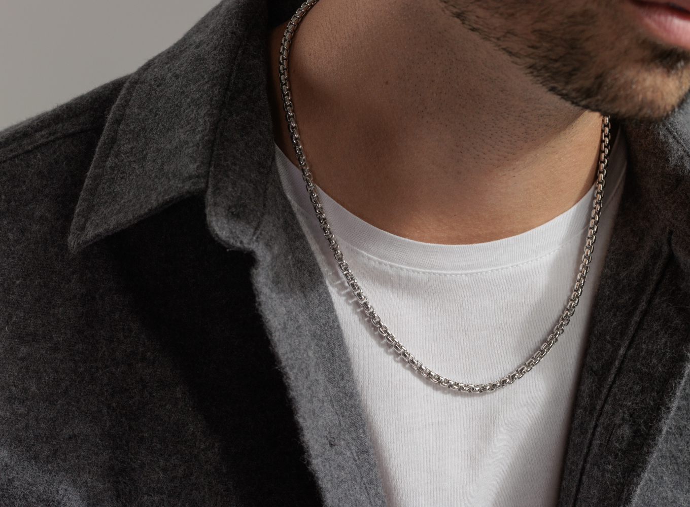 20 in Box Chain in Sterling Silver (4mm) This bright sterling silver box chain complements any look. The lobster clasp has a locking lever mechanism that will hold this necklace securely in place.