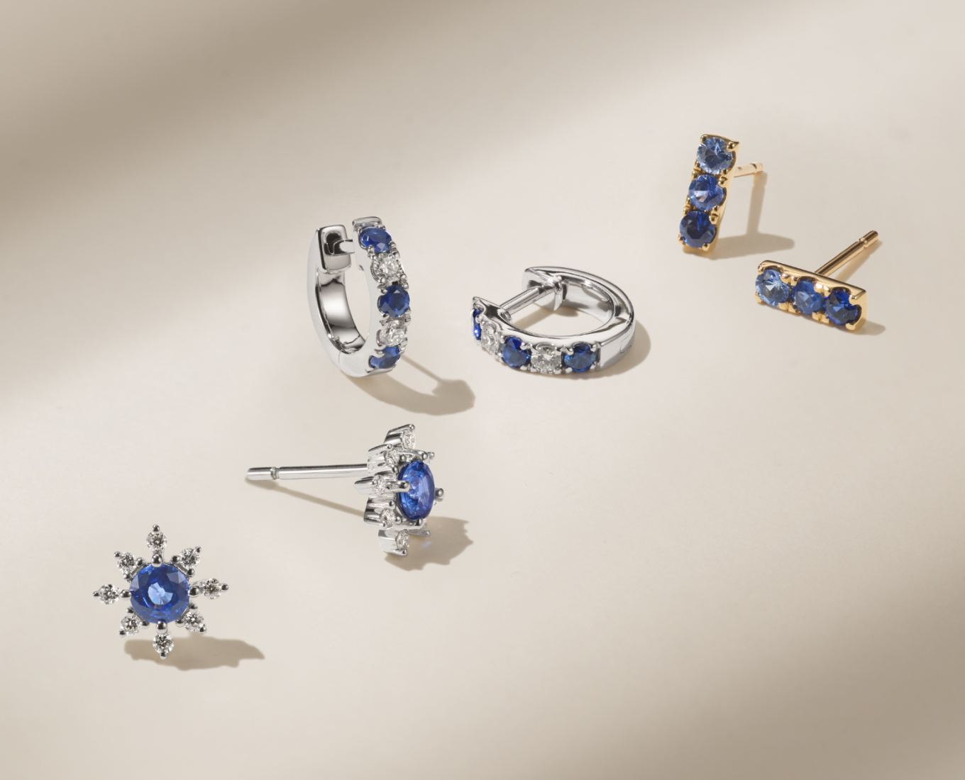 Kentucky Blue Sapphire and Diamond Star Earrings These beautiful earrings are crafted from quality 14 karat white gold. This pair features two round Kentucky blue natural sapphires (approx. .61 carat TW) and sixteen round natural diamonds (approx. .16 carat TW). With a total gem weight of approximately .77 carat these earrings are secured with friction backs.Traditional Blue Sapphire and Diamond Hoop Earrings in 14k White Gold Crafted in quality 14 karat white gold, these hoop earrings feature six round traditional blue natural sapphires (approx. .31 carat TW) alternating with four round natural diamonds (approx. .18 carat TW). These magnificent gems were hand-matched for exceptional color and sparkle. The total gem weight is approximately .49 carat. The earrings are just under 1/2 of an inch in diameter.Ombre Blue Sapphire Earrings in 14K Yellow Gold These lovely earrings are crafted from quality 14-karat yellow gold and feature six round multi-colored traditional blue natural sapphires, at approximately .44 carat total gem weight. These studs are secured with friction backs.