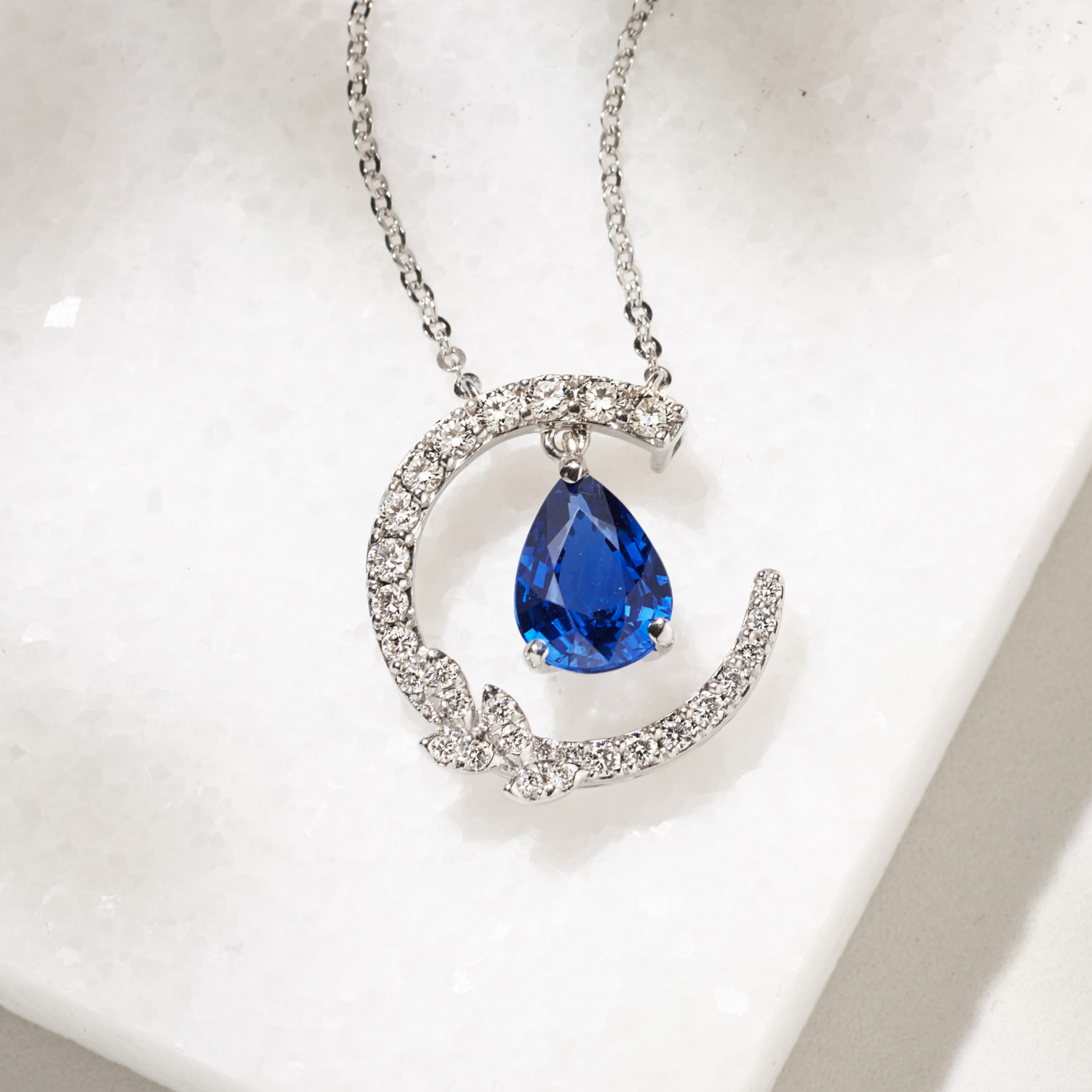 Pick-Your-Gem Leaf Necklace (18 in) Twenty-nine brilliant round natural diamonds, at approximately .31 carat total weight, will make the perfect accents to the 1.25 carats pear gemstone of your choice. This pendant is secured with a lobster clasp and hangs from a matching 18-inch cable chain. This piece is crafted from quality 14 karat white gold. For more information on selecting your center stone, Live Chat or call an online customer service representative at 1-866-467-4263, or visit one of our store locations.