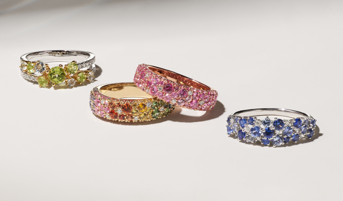 Verdi Green Quartz, Peridot & Diamond Ring Green quartz and peridot gemstones create a monochromatic cluster at the center of this beautiful crossover ring while natural diamond pavé shimmers on either side. It features two tones of gold with a 14-karat white gold band and 14-karat yellow gold surrounding the green gemstones. Mosaic Pink Sapphire & Diamond Ring (3.9mm) This beautiful ring features a monochromatic mosaic of natural pink sapphires dotted with natural diamond accents to create a bold pop of color. Its vivid 14-karat rose gold perfectly complements all the gemstones. Mosaic Rainbow Sapphire & Diamond Ring (3.9mm) A mosaic of multi-colored natural sapphires dotted with natural diamond accents creates a rainbow of color along this beautiful ring. Its warm 14-karat yellow gold beautifully complements all the gemstones. Santorini Sapphire & Diamond Cluster Ring Full of gorgeous color, this cluster ring features varying shades of natural traditional blue sapphire with sparkling natural diamond accents. This 14-karat white gold ring makes a beautiful and unique complement to any look.