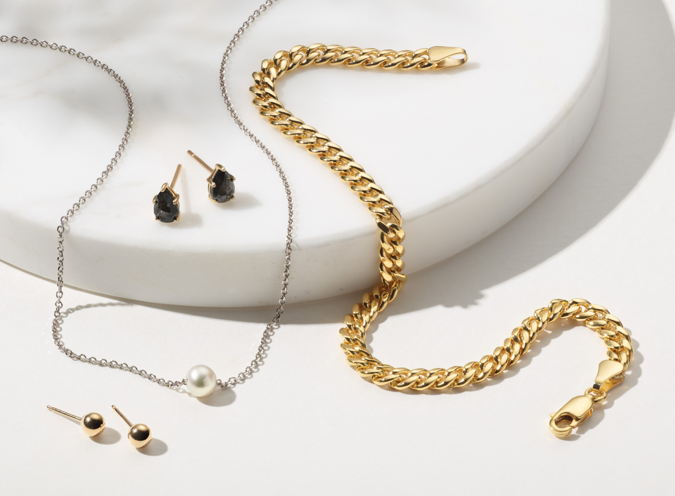 4mm 14K Yellow Gold Ball Studs Add shine to any outfit with these 14-karat yellow gold ball earrings. Comfortable enough for daily wear, they feature a secure friction back. 5mm Cultured Freshwater Pearl Necklace (18 in) This solitaire pearl necklace features a beautiful cultured freshwater pearl, perfect for a June birthday or anyone looking for a touch of simple elegance. Set on a 14-karat white gold cable chain, a lobster clasp keeps this look secure. Pepper Diamond Stud Earrings in 14K Yellow Gold Show-off your unique style with these lovely stud earrings. The natural pepper diamonds have been hand-matched for consistent color. Our shade of 14-karat yellow gold has added zinc, copper, and silver alloys that make a stunning color. The friction backs have engraving on the posts that use tension to hold the earrings in place. 7.5in 14K Yellow Gold Miami Cuban Bracelet (4.5mm) This stylish 14-karat yellow gold Miami Cuban chain bracelet will round out any look. A secure lobster clasp is perfect for worry-free daily wear.