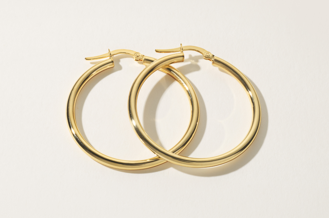 Bold Daily 14K Yellow Gold Hoops Slightly thicker than our Daily Hoops, these earrings feature the same classic look with a rounded profile and a lightweight feel, making them perfect for daily wear. A lever back keeps these beautiful 14-karat yellow gold hoops secure.
