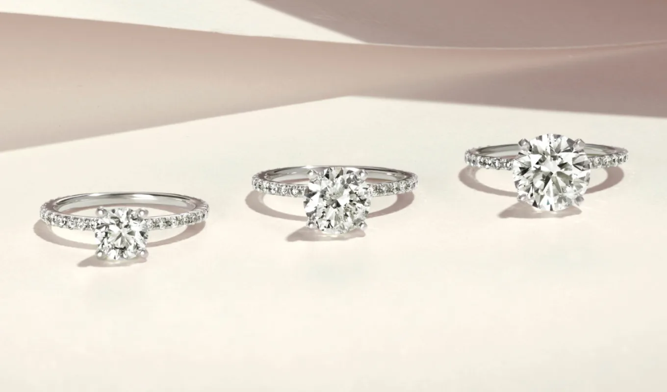Three diamond engagement rings, illustrating the center stone upgrade program at Shane Co.