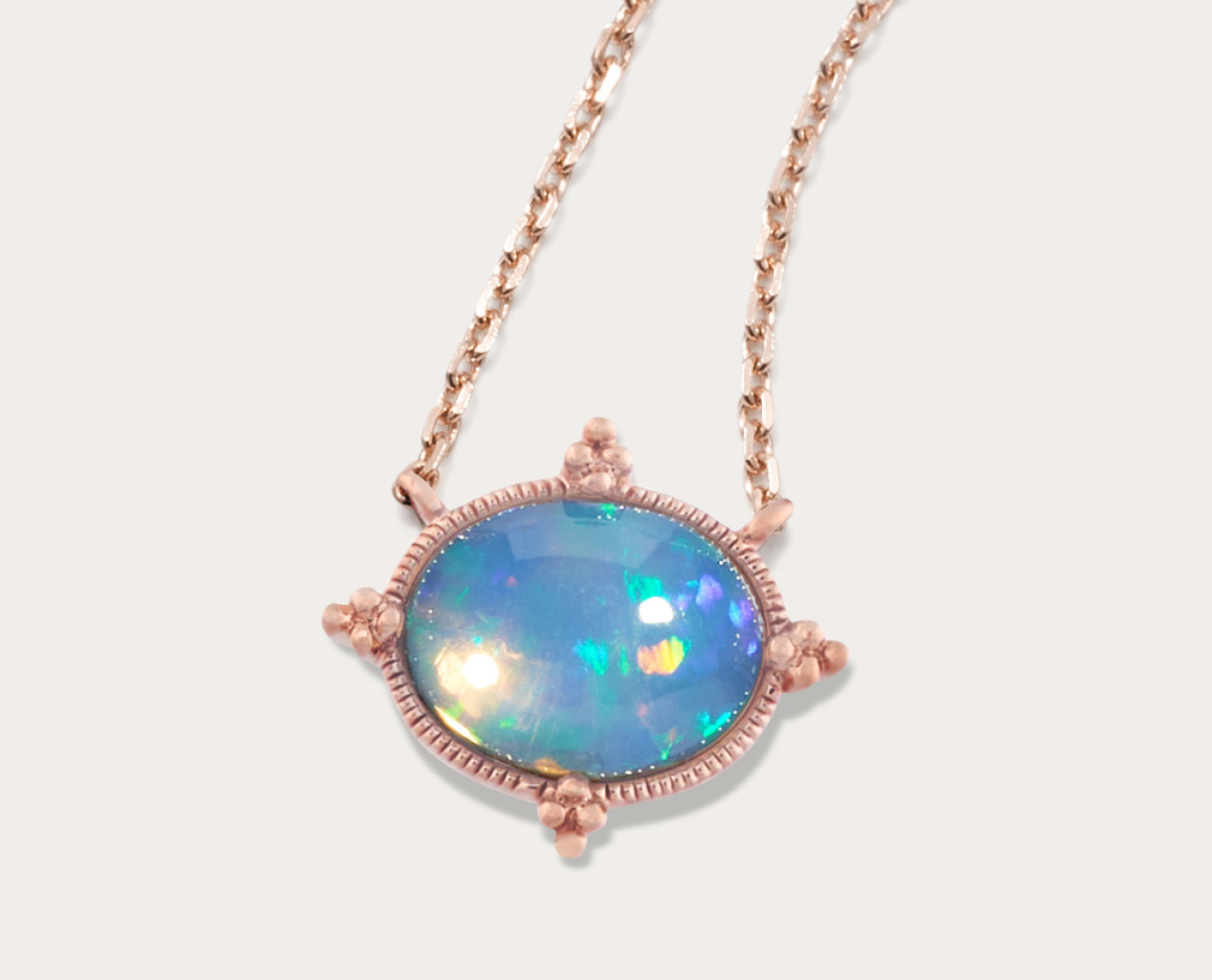 Beatrice Opal Necklace with Bead Accent in 14K Yellow Gold (20 in) Crafted from quality 14 karat yellow gold, one beautiful 9mm oval natural opal gemstone sits center stage in this 1/2 an inch long pendant. This is one of the highest quality natural Ethiopian natural opals and it hangs from a matching adjustable 20-inch diamond cut cable chain. This piece is secured with a lobster clasp. natural opal should be cleaned gently with mild detergent in warm water and a soft toothbrush or cloth. Avoid bleach, chemicals and cleaners and rapid temperature changes.