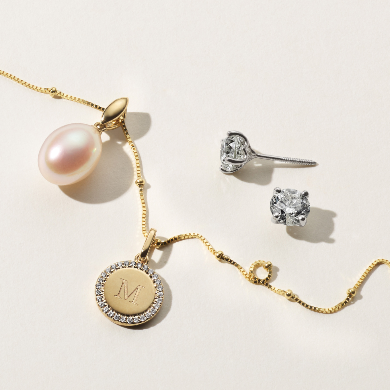 20in 14K Yellow Gold Satellite Box Chain (1.1mm) Add style to any outfit with this 14-karat yellow gold satellite box chain. It’s beautiful on its own or layered with other necklaces. 8mm Baroque Cultured Freshwater Pearl Charm This unique charm features a beautiful baroque cultured freshwater pearl. Crafted with a 14-karat yellow gold bail, add a chain to create a one-of-a-kind necklace. Diamond Halo Engravable Disk Charm A border of natural diamond accents adds hand-matched sparkle and fire to this 14-karat yellow gold disk charm. Add a custom engraving to make it personal. Diamond Studs